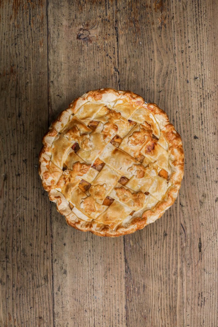 Republic of pie Peach cobbler pie placed on a wooden table. It is a baked good and a popular snack in North Hollywood, CA