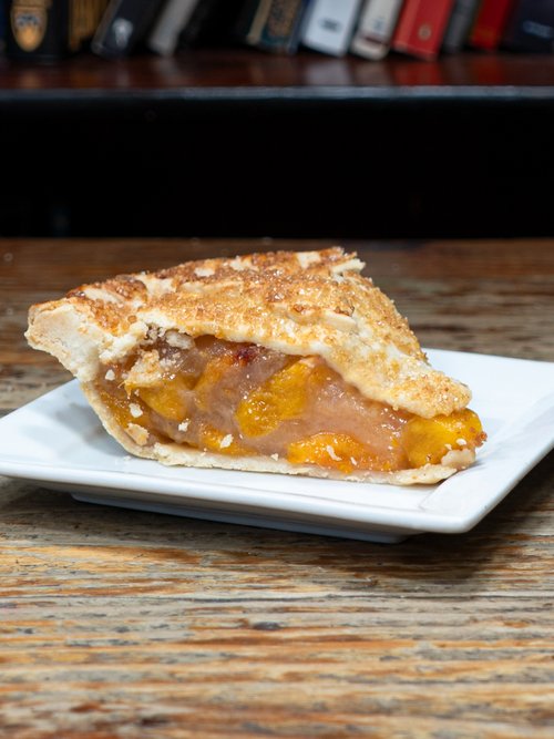 Peach cobbler is an iconic American dessert, bursting with the flavors of fresh peaches, sweetened with sugar, a hint of cinnamon, and topped with a delectable crumble topping.
