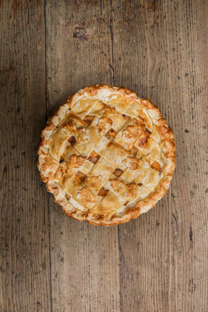 Republic of pie Peach cobbler pie placed on a wooden table.