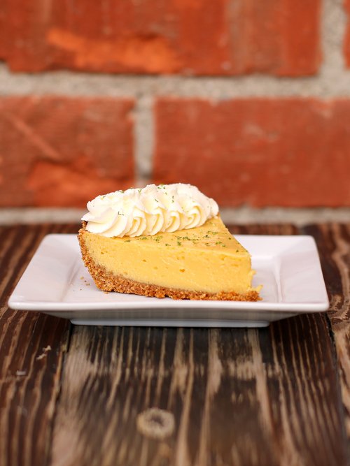 Handmade Key Lime Pie, featuring a refreshing citrus taste and a luscious, thick meringue topping. 